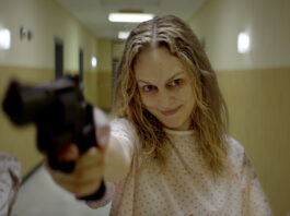 Heather Graham holding a gun in Suitable Flesh