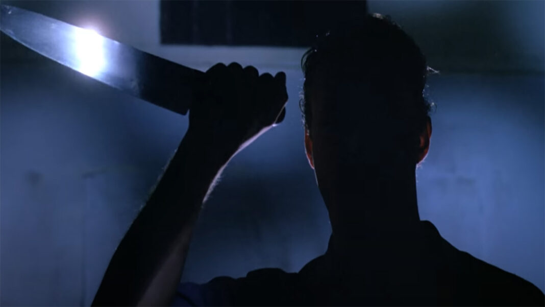 Intruder (1989) The silhouette of a person holding a knife in Intruder (1989)