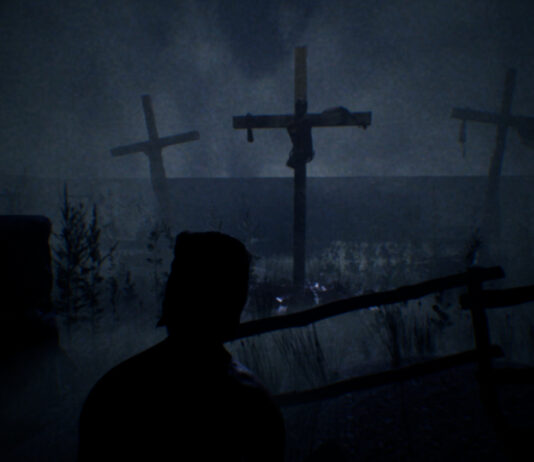A hooded man looking out at crucifixes in a field