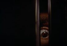 Billy's brown eye peering through a door in Black Christmas