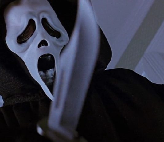 Ghostface holding a knife to the camera in Scream