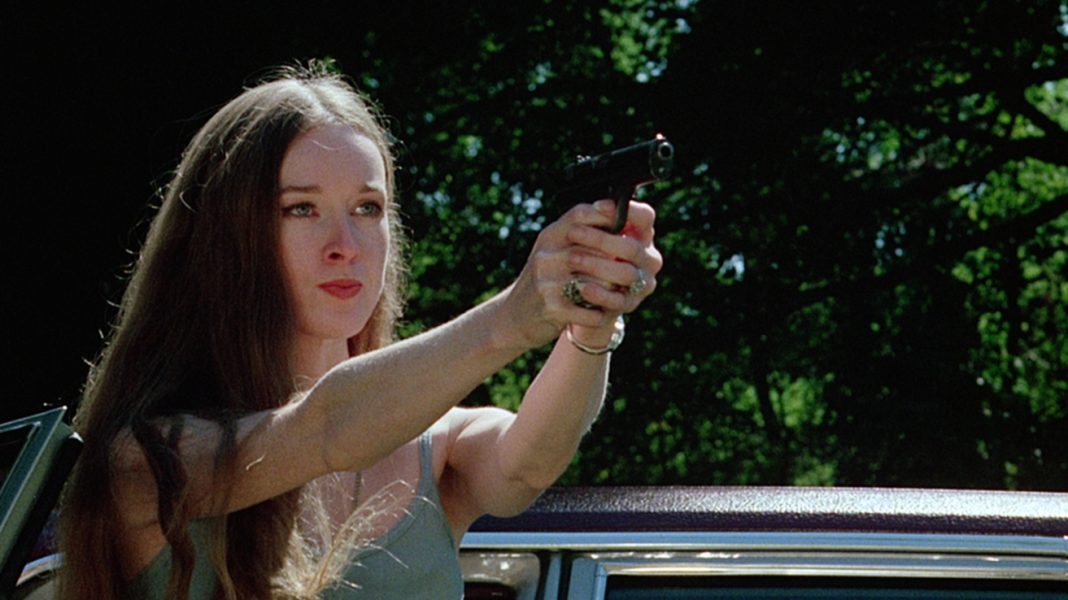 Camille Keaton holding a gun from I Spit on Your Grave (1978)