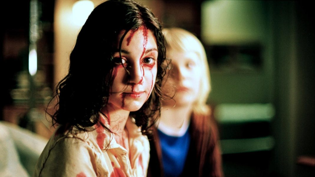 Lina Leandersson as Eli and Kåre Hedebrant as Oskar in Let the Right One In (2008)
