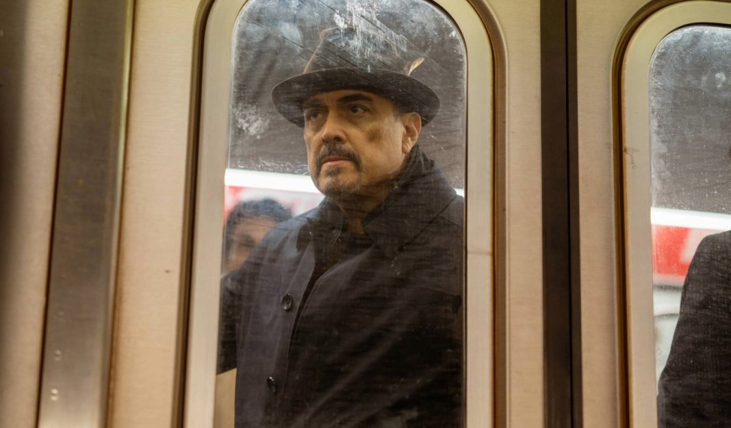 Angel stands in a subway car