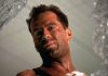 John McClane looks out of a window in Die Hard