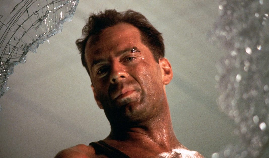 John McClane looks out of a window in Die Hard John McClane looks out of a window in Die Hard