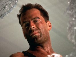 John McClane looks out of a window in Die Hard