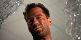 John McClane looks out of a window in Die Hard
