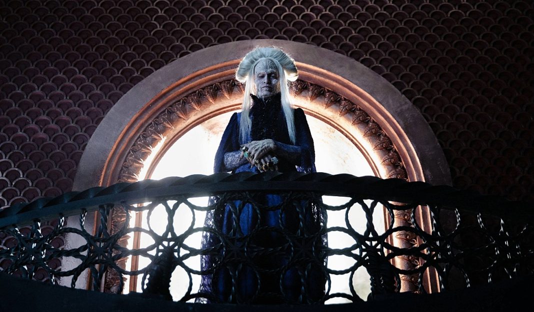 Caleb Landry Jones stands on a balcony as Dracula in Dracula 2026