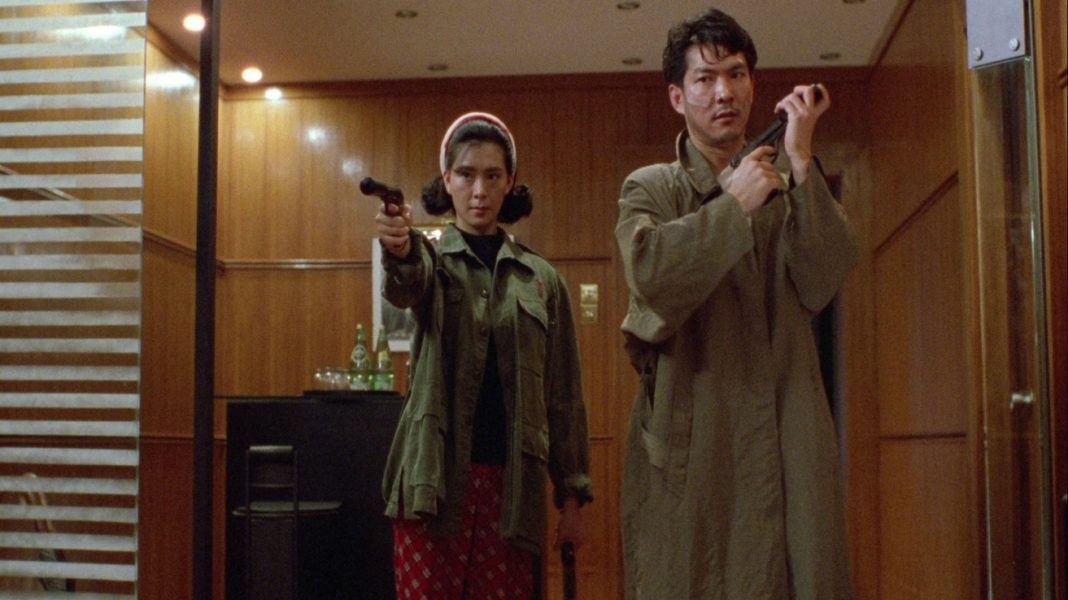 On the Run (1988) Two actors holding guns from On the Run (1988)