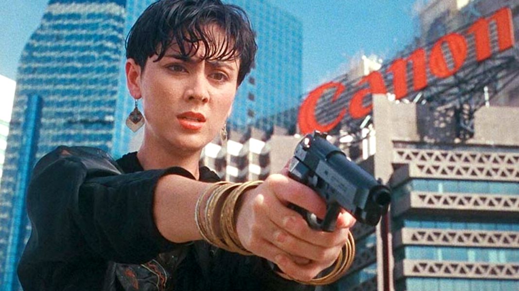 A woman points a gun at someone in She Shoots Straight (1990) A woman points a gun at someone in She Shoots Straight (1990)
