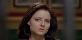 Clarice Starling (Jodie Foster) stands outside of Hannibal's cell in The Silence of the Lambs