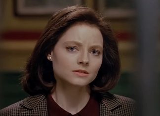 Clarice Starling (Jodie Foster) stands outside of Hannibal's cell in The Silence of the Lambs