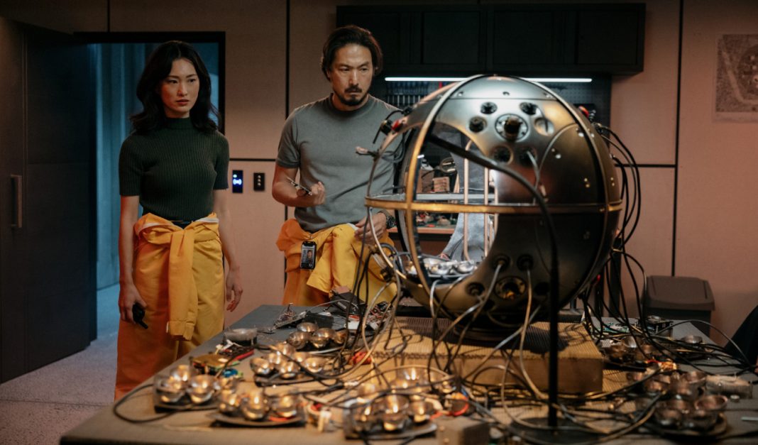 Keiko Miura (Mari Yamamoto) and Hiroshi Randa (Takehiro Hira) examine a scientific device in a lab in Monarch Legacy of Monsters Season 2, Episode 4 'Trespass'