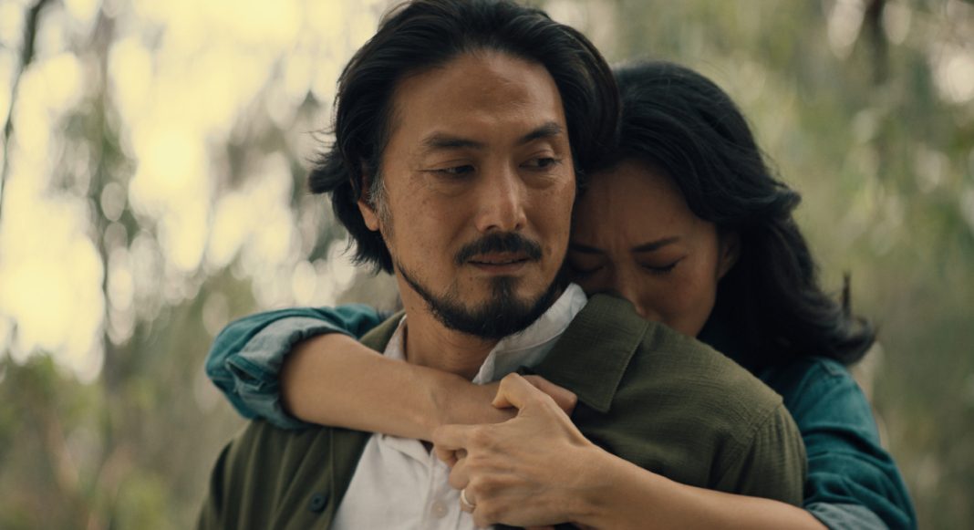 Keiko Miura (Mari Yamamoto) hugs Hiroshi Randa (Takehiro Hira) from behind while crying in Legacy of Monsters Season 2, Episode 5 'Furusato' Keiko Miura (Mari Yamamoto) hugs Hiroshi Randa (Takehiro Hira) from behind while crying in Legacy of Monsters Season 2, Episode 5 'Furusato'