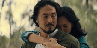 Keiko Miura (Mari Yamamoto) hugs Hiroshi Randa (Takehiro Hira) from behind while crying in Legacy of Monsters Season 2, Episode 5 'Furusato'