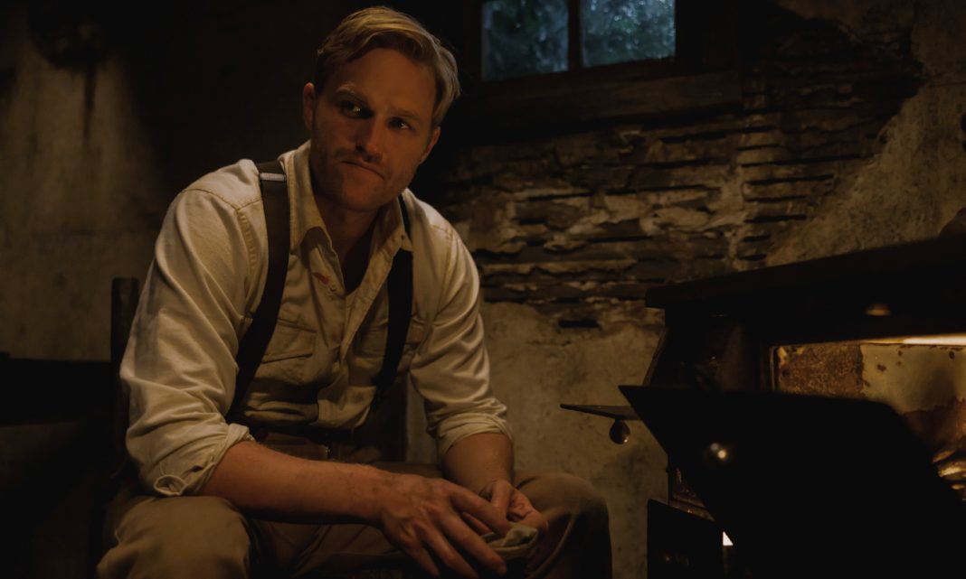Wyatt Russell sits in a room in Monarch Legacy of Monsters Season 2, Ep. 3 'Secrets'