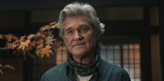 An older Lee Shaw (Kurt Russell) looks concerned while standing in house in Monarch Legacy of Monsters Season 2, Episode 7