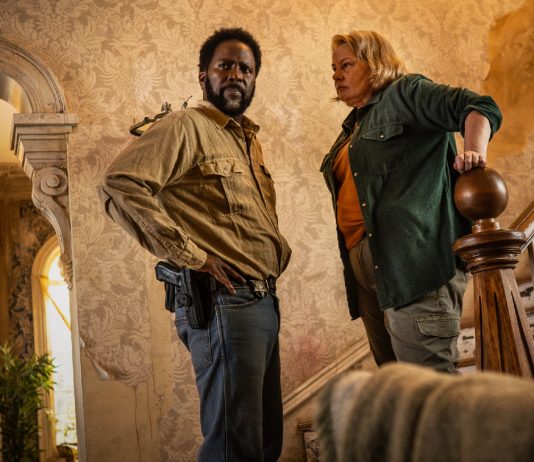 Boyd and Donna Raines talk while they stand at a staircase in FROM Season 4 Episode 1