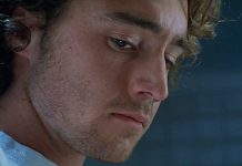 Simon looks down while in an interview in The Ugly