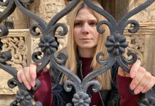 A woman stands at a gate in Transylvania Tapes