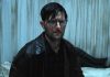 Adam Scott's character looks stunned while covering in a substance in Hokum