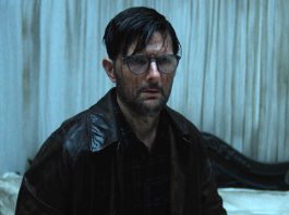 Adam Scott's character looks stunned while covering in a substance in Hokum