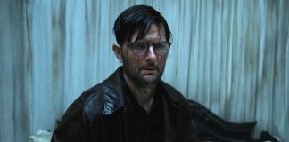 Adam Scott's character looks stunned while covering in a substance in Hokum