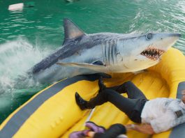 In a life raft, Aaron Eckhart's character fights off a shark in Deep Water