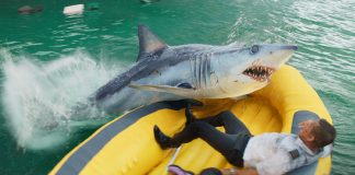 In a life raft, Aaron Eckhart's character fights off a shark in Deep Water