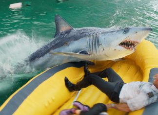 In a life raft, Aaron Eckhart's character fights off a shark in Deep Water