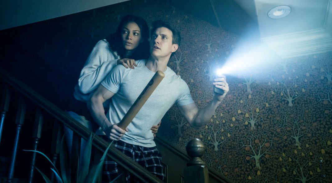 A husband and wife come down the stairs in fear in the Paranormal Activity Stage Play