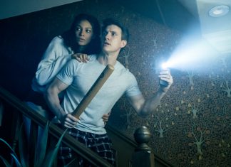 A husband and wife come down the stairs in fear in the Paranormal Activity Stage Play