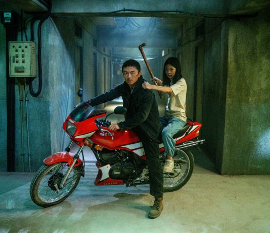 A man and his daughter sit on a motorcycle in The Furious
