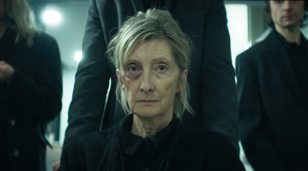 A woman gets pushed in a wheelchair to a funeral in The Voices of Our Mother A woman gets pushed in a wheelchair to a funeral in The Voices of Our Mother