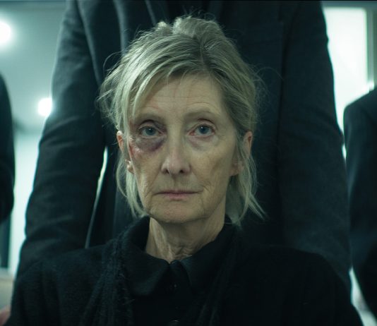 A woman gets pushed in a wheelchair to a funeral in The Voices of Our Mother