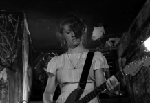 ‘The Yellow Bellies’ Blu-ray Review: A Gritty, Raw Punk Story A woman plays the guitar while on stage in The Yellow Bellies