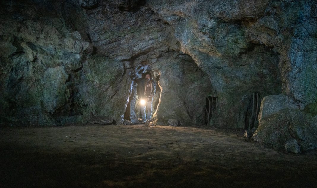 Jade Herrera enters a cave while holding a flashlight in From Season 4 Episode 9