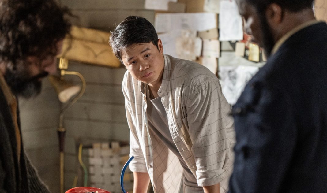 Kenny Liu leans over a table while talking to Jade Herrera and Boyd Stevens in From Season 4 Episode 9