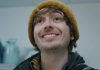 Bryan (Austin Abrams) smiles in the hospital in Resident Evil reboot