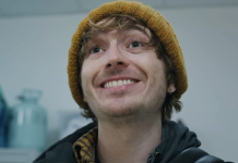 Bryan (Austin Abrams) smiles in the hospital in Resident Evil reboot