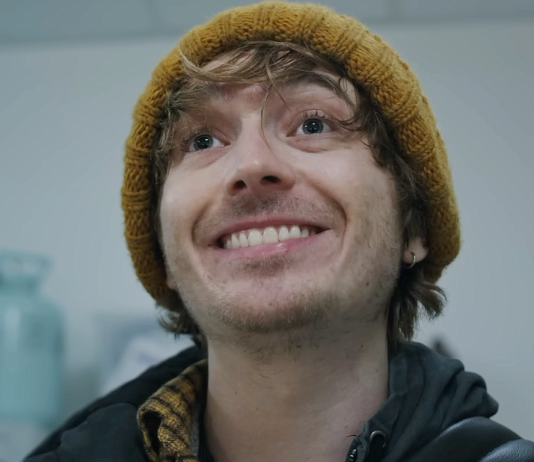 Bryan (Austin Abrams) smiles in the hospital in Resident Evil reboot