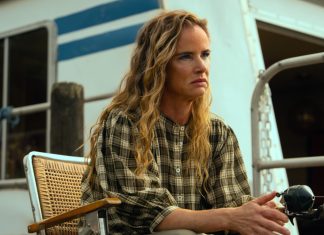 Crystal (Juliette Lewis) sits on the houseboat deck, fishing, in Cape Fear Episode 9