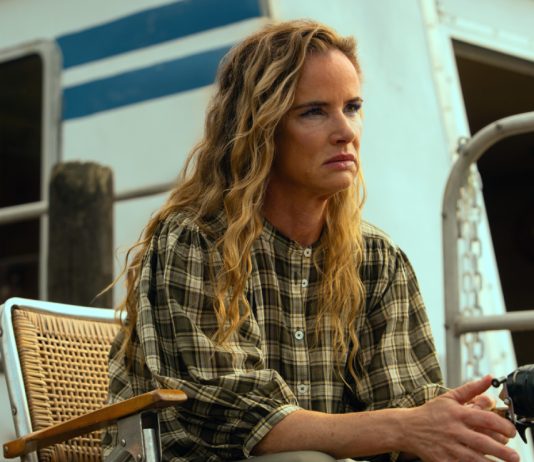 Crystal (Juliette Lewis) sits on the houseboat deck, fishing, in Cape Fear Episode 9
