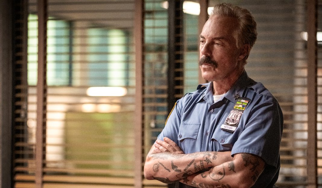 Officer Glenn Keenan (Titus Welliver) crosses his arms while in uniform in The Westies Episode 1