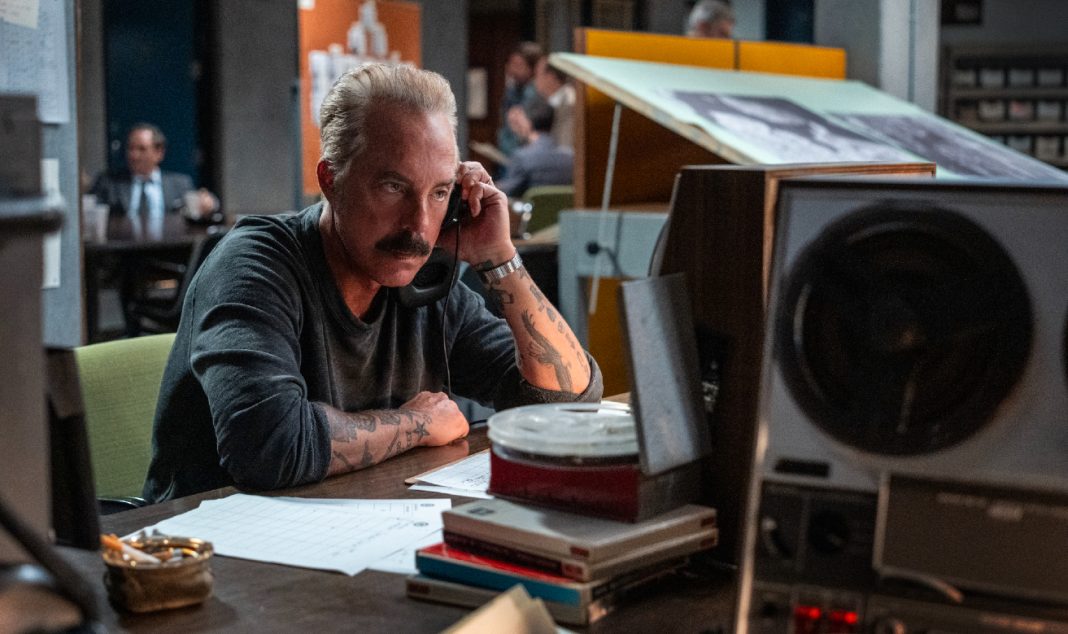 Officer Glenn Keenan (Titus Welliver) listens to a phone tap in The Westies Episode 7