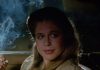Linda Hamilton smokes while talking to someone in a car in TAG The Assassination Game