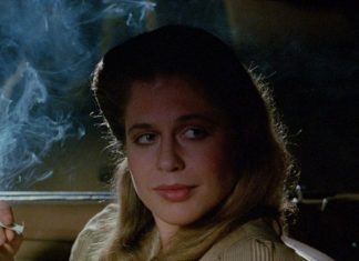 Linda Hamilton smokes while talking to someone in a car in TAG The Assassination Game