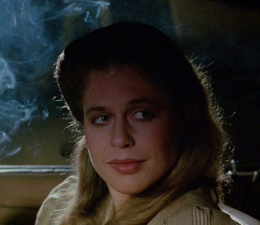Linda Hamilton smokes while talking to someone in a car in TAG The Assassination Game