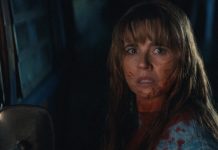 Pam Voorhees (Linda Cardellini) stands next to a truck, covered in blood, in Crystal Lake